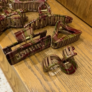 Close-up of assorted geometric hair claws featuring classic red and green plaid patterns