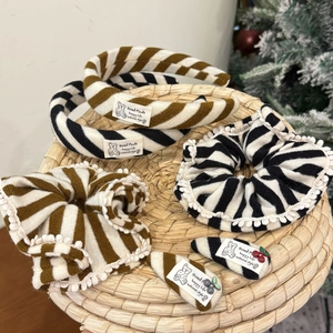 Detalle de diademas y coleteros de punto a rayas con parches de osos y bordes de encaje