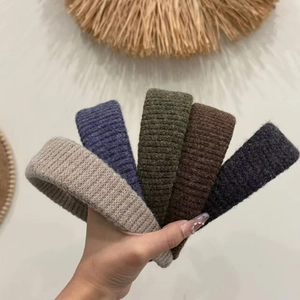 Macro shot of assorted color knitted headbands showing thick ribbed wool texture and details
