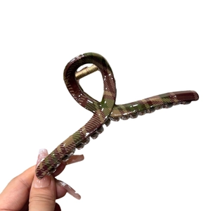Large dark green plaid hair claw clip with classic resin pattern and glossy finish