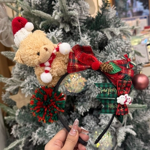 Christmas headband featuring a plush teddy bear with plaid bows and pine cone decoration