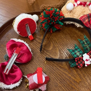 Detail view of Christmas hair clips and headbands with snowman and bow designs