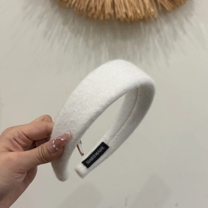 Solid white wool padded headband with high top design and handmade label for women