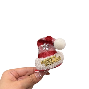 Mini Christmas hat hair clip with red and silver stripes and Merry Xmas gold lettering