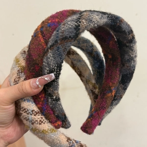 Close-up of thick textured tweed headbands in various colors with frayed edge details