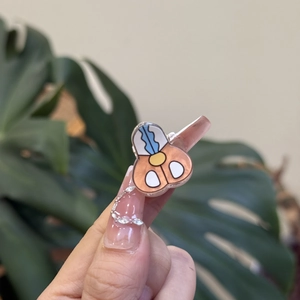 Detailed close-up of a cartoon acrylic hair clip with vibrant 3D character design