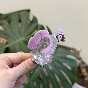 Cute acrylic puffin hair claw clip with pink accessories and pearlescent finish