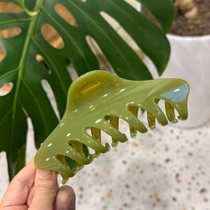 Close-up of the large green resin hair claw clip with a glossy finish and strong spring