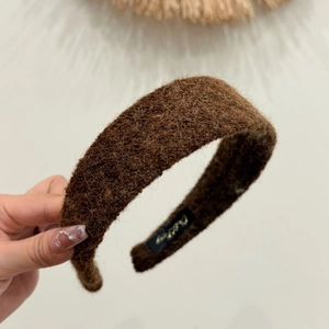 Wide fuzzy felt headband in deep brown with wool texture for a minimalist winter style