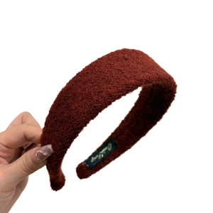 Handheld wide felt headband in caramel red color with soft warm texture for women