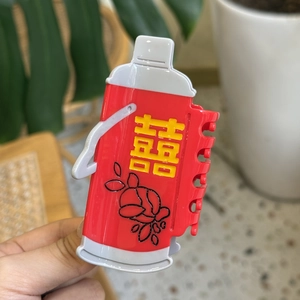 Festive red thermos-shaped acetate hair claw clip with yellow Xi character design