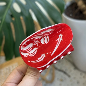 Festive red acetic acid shark hair claw clip with white floral patterns and glitter finish