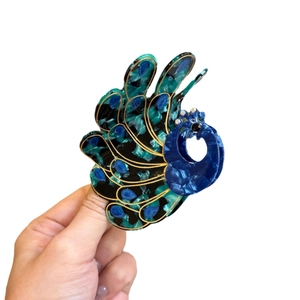 Deep blue peacock acetate hair claw clip with crystal accents and gold-trimmed details