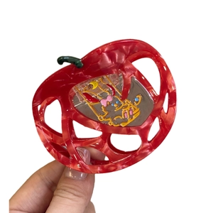 Red acetate apple claw clip with kitten moon detail and green leaves for festive wedding styles
