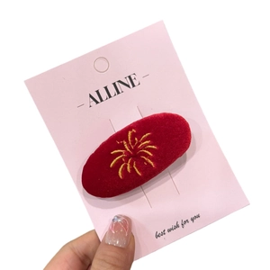 Elegant red velvet oval hair clip with gold firework embroidery for festive styling