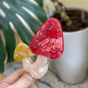 Creative mushroom hair claw clip with colorful marble texture and shiny rhinestones