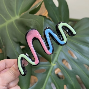 Detail of wavy colorful resin hair claw clip with macaron pink blue and green oil drip finish