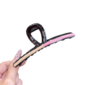 Black wavy hair claw clip with pink and beige color-blocking design for women