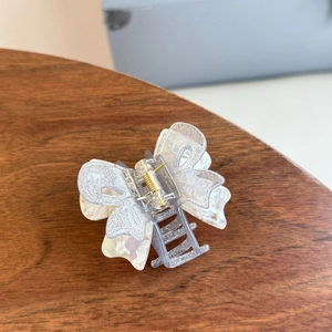 Elegant double-layered butterfly hair claw with grey glitter and white marble finish
