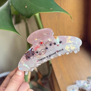Cute acrylic cat hair claw clip with heart patterns and pearlescent pink finish