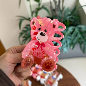 Pink iridescent acrylic teddy bear hair claw clip with KISS heart and bow design