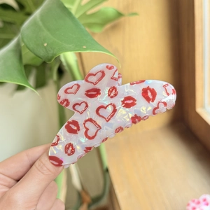 Chic acrylic hair claw with red heart and lip prints in a sweet pearlescent finish