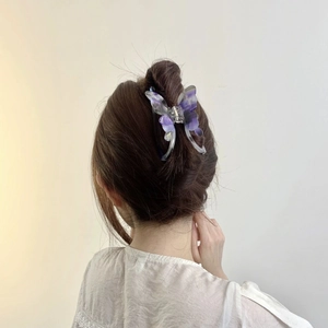 Elegant purple gradient butterfly acetate hair claw clip worn in a stylish updo hairstyle