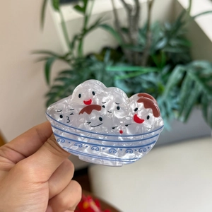Acrylic hair claw with cute white dumpling bowl design and shimmering pearl texture finish