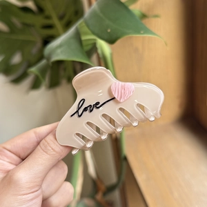 Medium acetate cat hair claw clip in cream with love text and pink heart detail