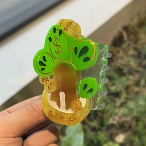 Creative money tree hair claw clip with RICH text and dollar signs in green acrylic