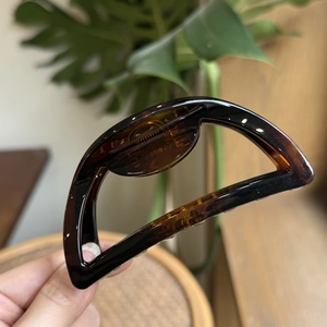 Close-up of tortoise shell pattern hair claw clip with Made in France engraving details