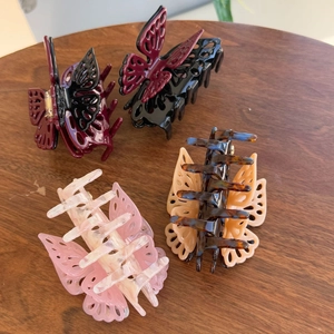 Set of four butterfly hair claws in burgundy, pink marble, and tortoiseshell patterns