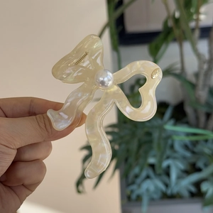 Elegant cream acetate bow hair claw clip with pearl accent for spring hairstyles