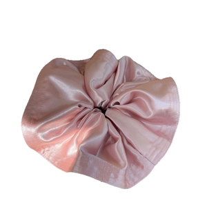 Elegant large pearlescent pink satin scrunchie with soft pleated texture and silky shine