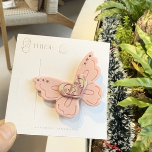 Sweet pink butterfly hair clip with heart detail and rhinestones on display card