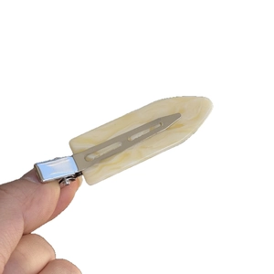 Chic cream marble acetate hair clip with silver metal base on a white background