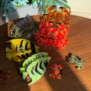 Assorted ocean-themed acetate hair claws featuring crab and tropical fish shapes