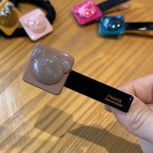 Detail of bear acetate hair clip featuring gold France Handmade lettering