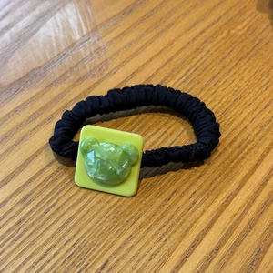 Cute bear charm hair tie with neon green square base and black pleated fabric elastic