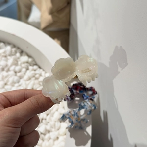 Handmade acetate flower hair claw in pearlescent ivory white with gold lettering