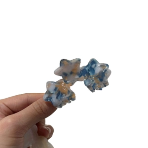 Star-shaped acetate hair clip with blue marble pattern and France Handmade gold logo