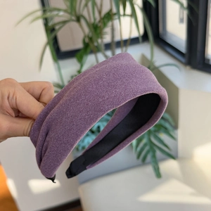 Detail of wide violet wool headband featuring plush texture and black non-slip inner lining