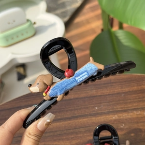 Cute black claw clip with brown dachshund dog wearing denim overalls for women