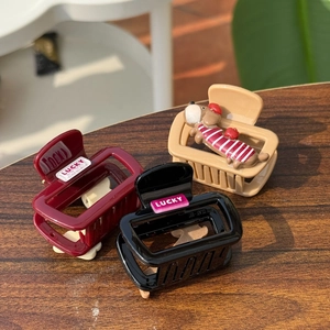Three Korean resin hair claws in burgundy, black, and apricot with cute dachshund doll
