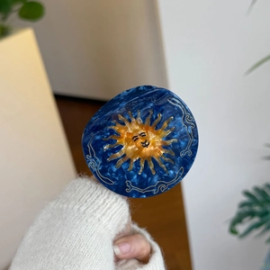Retro marble acetate hair claw clip with smiling sun pattern and golden details