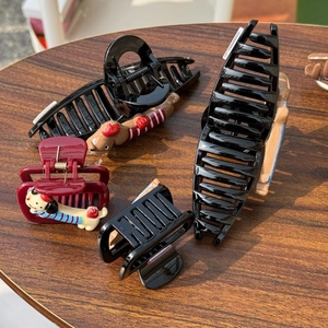 Detailed set of cartoon dog hair claws in black and burgundy on a wooden surface