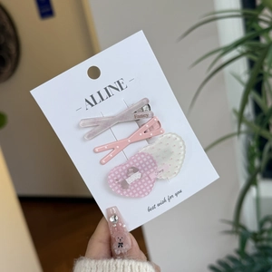 3-piece sweet hair clip set with pink checkered heart and puppy patterns on display card