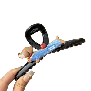 Cute black hair claw clip featuring a 3D dachshund wearing a blue sweater and red apple detail