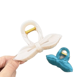 Elegant cream bow hair claw clip with gold metal spring for minimalist styling