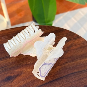 Floral acrylic hair claws with Fancy text and golden spring on wooden background